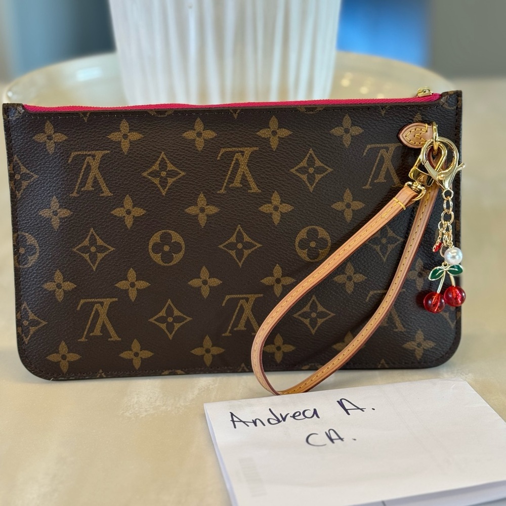 Louis Vuitton Brown Clutch with Iconic Monogram Pattern and Leather Wrist Strap